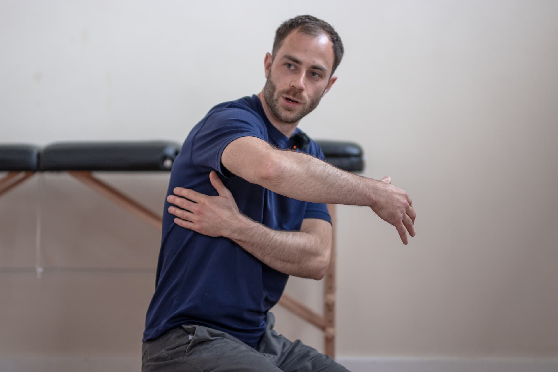 Therapist demonstrating a shoulder stretch for the exercise library