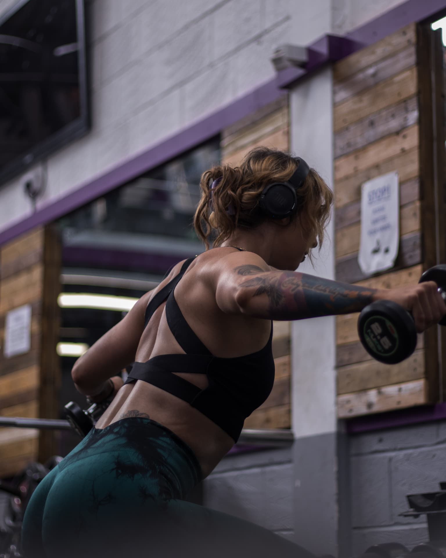 Coach performing a dumbbell raise during an HRC Coaching shoot