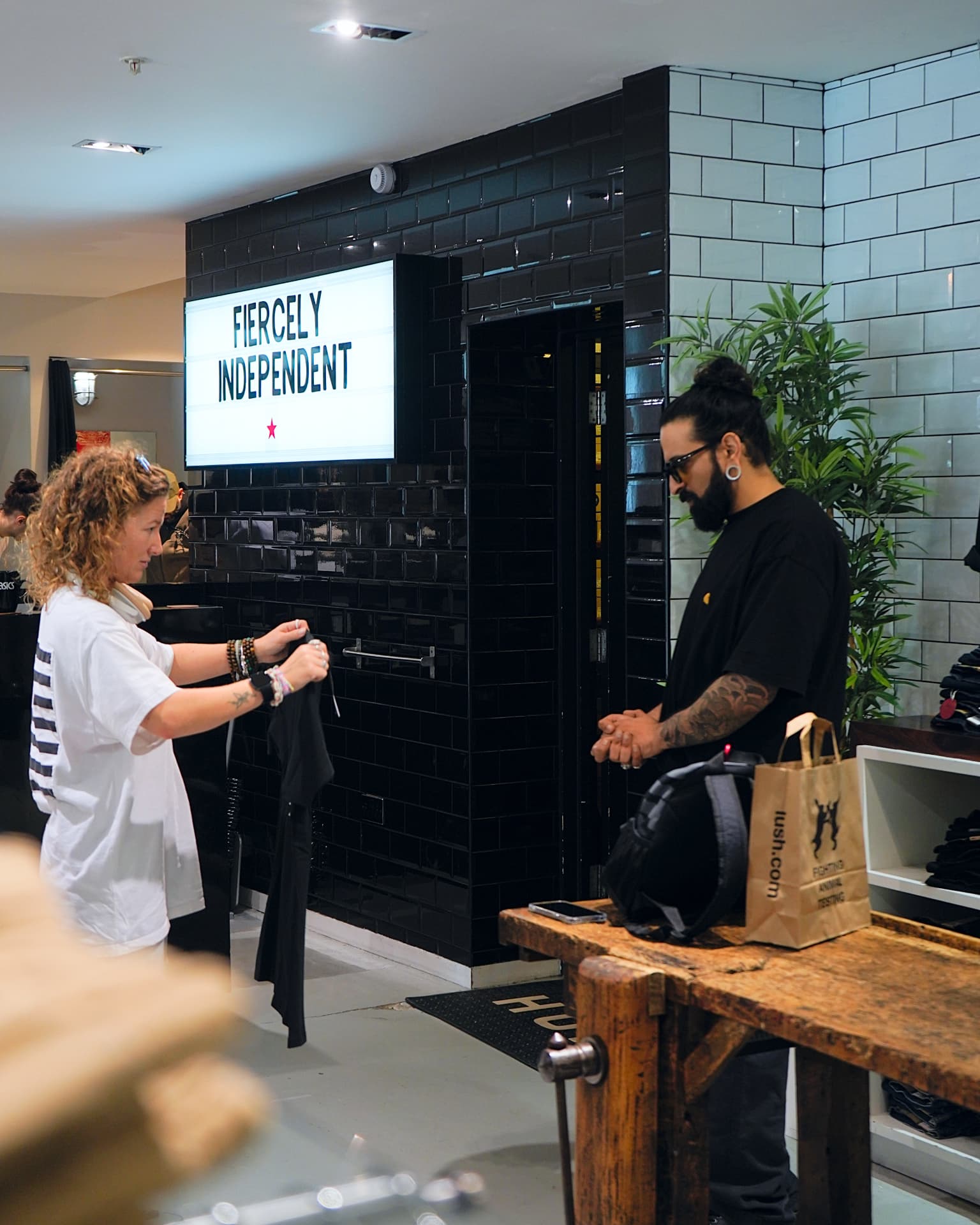 Customer being served near the Fiercely Independent display