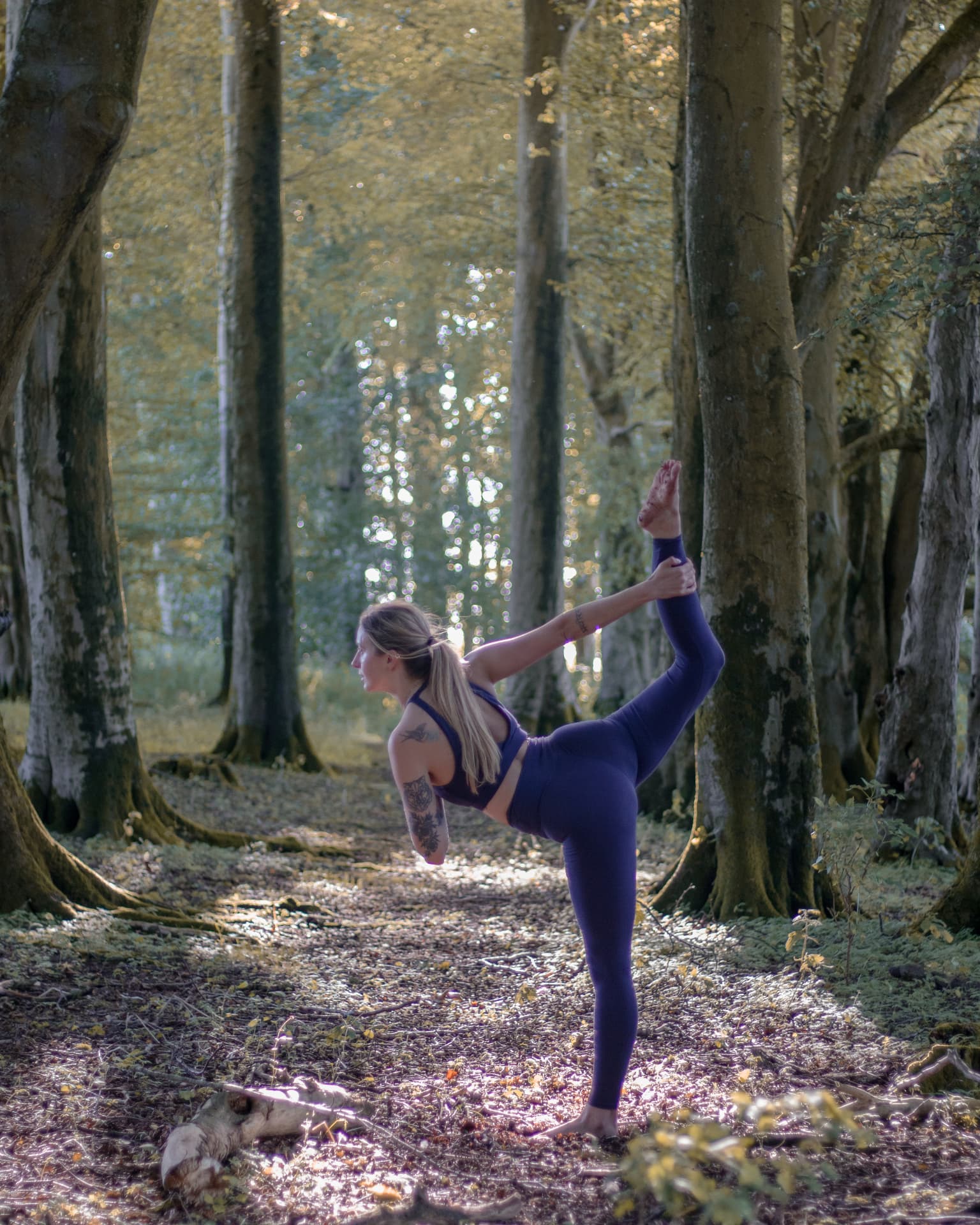Yoga coach in a golden-hour backbend on a hilltop